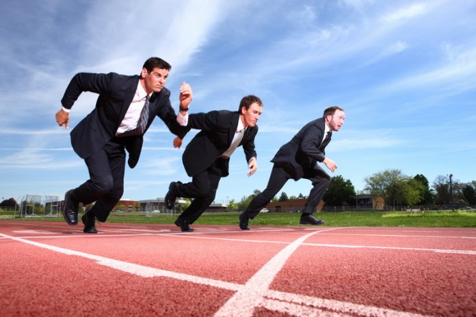 Businessmen running on track